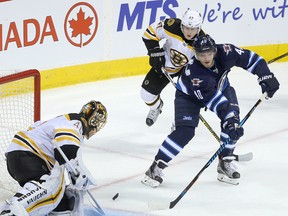 Boston Bruins goalie Tuukka Rask (l) and defenceman Torey Krug stop a shot by Winnipeg Jets right winger Joel Armia during NHL hockey in Winnipeg, Man. Monday October 17, 2016. Brian Donogh/Winnipeg Sun/Postmedia Network