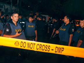 Bangladeshi security officers cordon off an area after heavily armed militants attacked a restaurant in Bangladesh's diplomatic zone in Dhaka, Bangladesh on Saturday, July 2, 2016. Bangladeshi forces stormed the popular Holey Artisan Bakery in Dhaka's Gulshan area to end a hostage-taking. (AP Photo)