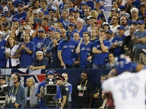 Nervous fans watch Toronto Blue Jays' Jose Bautista draw a walk during the seventh inning of game three of the American League Championship Series in Toronto on Monday Oct. 17, 2016. Michael Peake/Toronto Sun/Postmedia Network