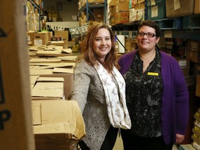 Luke Hendry/The Intelligencer
Gleaners Food Bank's Kirsten Geisler, left, and Louise Wood stand next to some of the newly-arrived food in the warehouse Monday. Sunday's annual food drive brought in at least 22 skids such as these, enough to stock the building for about six months.