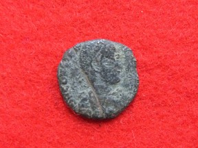 This Sept. 21, 2016 photo released by Uruma City Board of Education shows the head of a coin, which is likely dating to the Roman Empire, found with nine other coins during an excavation at Katsuren Castle in Uruma on Japan's southernmost prefectural island of Okinawa. The 10 copper coins were unearthed in December 2013 at the 12th-15th century Katsuren Castle, a UNESCO World Heritage site, during an annual excavation for study and tourism promotion by the board of education in Uruma, a city in central Okinawa. While the find has yet to be submitted for publication in an academic journal, an outside expert is convinced that the coins are real. (Uruma City Board of Education via AP)