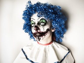 A closeup of a scarier clown with sharp pointy teeth glaring at you. (Getty Images)