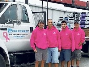 Preferred Building Products Ltd. is among the many individuals, businesses and organizations that are helping raise awareness during Breast Cancer Awareness Month this October. Employees are making deliveries in bright pink sweatshirts during the month, and the company's four trucks have the pink ribbon symbol for breast cancer awareness on their doors all year long. From left are John Thompson, Vince Roy, Ashwin Roy and Brad Tulp.