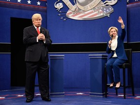 In this Oct. 15, 2016 photo provided by NBC, Alec Baldwin, left, as Republican presidential candidate, Donald Trump, and Kate McKinnon, as Democratic presidential candidate, Hillary Clinton, perform during the during the "Debate Cold Open" sketch. (Will Heath/NBC via AP)