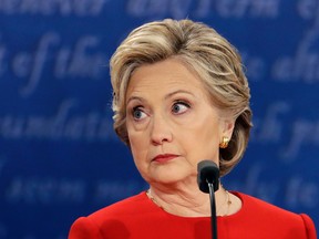 In this Sept. 26, 2016 file photo, Democratic presidential nominee Hillary Clinton listens to Republican presidential nominee Donald Trump during the U.S. presidential debate at Hofstra University in Hempstead, N.Y. Clinton privately said the U.S. would "ring China with missile defense" if the Chinese government failed to curb North Korea's nuclear program, a potential hint at how the former secretary of state would act if elected president. Clinton's remarks were revealed by WikiLeaks in a hack of the Clinton campaign chairman's personal account. (AP Photo/Julio Cortez, File)