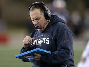 New England Patriots head coach Bill Belichick studies a tablet device along the sideline during the first half of an NFL football game. (AP Photo/Charles Krupa, File)