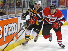 Ottawa 67's Noel Hoefenmayer outmuscles Kingston Frontenacs’ Cody Caron behind the 67's net during Ontario Hockey League action at the Rogers K-Rock Centre on Oct. 9. (Steph Crosier/The Whig-Standard)