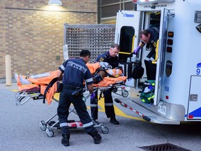 Paramedics transport one of the shooting victims to Sunnybrook trauma centre Tuesday evening. Somebody opened fire on a vehicle in Rexdale. (Victor Biro/Special to Toronto Sun)