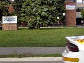 A police car drives by the main entrance of Polyvalente Hyacinthe-Delorme, a school located on the south shore of Montreal on September 19, 2016. (Marie-France Coallier/MONTREAL GAZETTE)