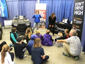 Schoolchildren and their teacher listen as Denise Erickson, left, and Melanie Trottier talk about ATV safety during the Racing Against Drugs event in Kingston on Tuesday. Grade 6 children rotated through interactive displays on healthy, substance-free living. (Michael Lea/The Whig-Standard)