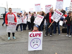 Sherri Pageau, left, and her son, Mathieux, 2, take part in a rally for laundry workers at Sudbury Hospital Services on Tuesday. John Lappa/Sudbury Star