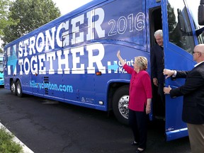 Democratic presidential nominee former Secretary of State Hillary Clinton and her husband former U.S. president Bill Clinton walk off of their campaign bus before a campaign rally at K'Nex, a toy company, on July 29, 2016 in Hatfield, Pennsylvania. A campaign bus similar to this one was spotted dumping sewage into a storm drain along a road outside Atlanta. The Democratic National Committee has apologized for the incident. (Photo by Justin Sullivan/Getty Images)