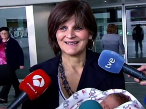 In this screen grab taken from video on Tuesday, Oct. 18, 2016, Lina Alvarez leaves Lucas Augusti Hospital with her new born baby, in Madrid, Spain. A 62-year-old Spanish woman has given birth to a healthy girl and encourages women in their later years to imitate her if they want to. (Atlas TV via AP)