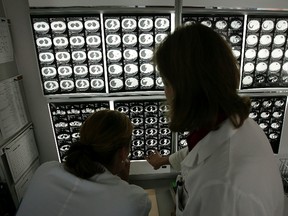 Dr. Julie Brahmer (R) and Katie Thornton review PET scans of a patient being treated at the Kimmel Comprehensive Cancer Center at Johns Hopkins August 15, 2005 in Baltimore, Maryland.  According to statistics released by the Canadian Cancer Society, there are more than 202,000 cancer cases this year. (Win McNamee/Getty Images)