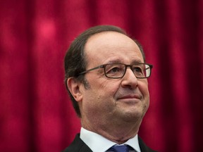 In this Sunday, Oct. 2016 file photo, French President Francois Hollande stands during a meeting with International Olympic Committee President Thomas Bach at the Elysee Palace in Paris. Normally a man of consensus and caution, President Francois Hollande’s frank comments in a new book written by two journalists is causing shockwaves in France. “A President Shouldn’t Say That ...” has exposed the inner workings of Hollande’s troubled presidency and his views on Islamic veils, Barack Obama and his private life. (AP Photo/Kamil Zihnioglu, Pool, File)