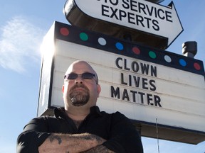 Napa Autopro supervisor Jon Adler stands by the "Clown lives matter" sign posted outside of the shop on Wellington Road. Derek Ruttan/The London Free Press/Postmedia Network