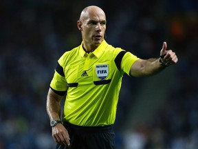 In this Tuesday, Oct. 1, 2013 file photo, referee Howard Webb gestures during the Champions League group G soccer match between FC Porto and Atletico de Madrid in Porto, northern Portugal. (AP Photo/Armando Franca, file)