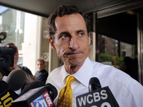 In this July 24, 2013 file photo, New York City mayoral candidate Anthony Weiner leaves his apartment building in New York. (AP Photo/Richard Drew, File)
