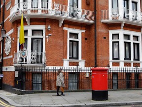 A woman walks past the Ecuadorian Embassy in London, Tuesday, Oct. 18, 2016. (AP Photo/Alastair Grant)