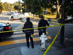San Francisco Police stand at the site of a shooting outside the June Jordan School for Equity and City Arts and Technology High School, which share a campus, in San Francisco, Calif., Tuesday, Oct. 18, 2016. Several teenage students were shot in the shared parking lot of the two San Francisco high schools Tuesday, and one of the students is in critical condition, authorities said. (Scott Strazzante/San Francisco Chronicle via AP)
