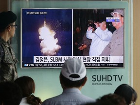In this Thursday, Aug. 25, 2016, file photo, a South Korean soldier watches a TV news program showing images published in North Korea’s Rodong Sinmun newspaper of North Korea’s ballistic missile at Seoul Railway station in Seoul, South Korea. (AP Photo/Ahn Young-joon, File)
