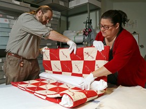 Luke Hendry/The Intelligencer
David Cox and Melissa Wakeling prepare a quilt made in 1920 for storage at Glanmore National Historic Site Wednesday in Belleville. Padding the folds with tissue paper prolongs its life. Experts will share tips for preserving family heirlooms and documents during an Oct. 22 drop-in education session at Glanmore.