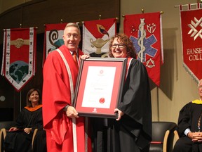 Fanshawe College President Peter Devlin presents Kelly Gilson with an honorary diploma at the 2016 graduation ceremony for Fanshawe College's Woodstock campus on Wednesday, October 19, 2016. (MEGAN STACEY/Sentinel-Review)