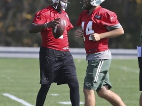 Jets quarterback Geno Smith (left) will be starting in place of Ryan Fitzpatrick on Sunday. (Seth Wenig/AP Photo)
