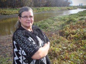 Activist Louise May stars on the bank of the LaSalle River in Winnipeg, Man. Monday October 17, 2016. May is worried about the environmental impact on the river from the Energy East Pipeline.