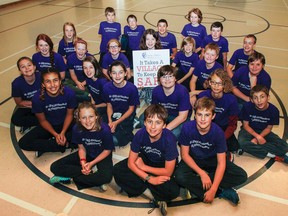 The students in Ryan Borges’s Grade 7/8 class at J.J O’Neill Catholic School in Napanee help to spread the message that "It takes a village to keep kids safe," as part of the #ibreakthesilence chid abuse awareness campaign for the month of October. (Julia McKay/The Whig-Standard)