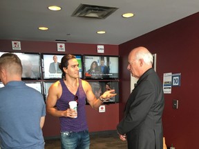 RJ Skinner, sporting a tank top, with legendary anchorman Peter Mansbridge. (Supplied photo)