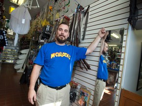 Dale McCulloch of McCulloch's points to the empty space in the Dundas Street costume shop where his stock of native headdresses had been displayed before removing them in response to an online petition, in London. (CRAIG GLOVER, The London Free Press)