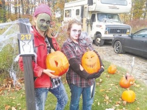 A family picks a pumpkin along the Savour Stratford Pumpkin Trail.