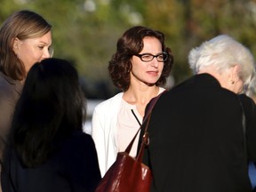 Sabrina Erdely, center, enters the federal courthouse in Charlottesville, Va., on Monday, Oct. 17, 2016. Erdely, author of "A Rape on Campus," a discredited Rolling Stone article detailing an alleged rape at the University of Virginia, is being sued by Nicole Eramo, a UVa administrator included in the story. (Ryan M. Kelly/The Daily Progress via AP)