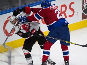 Edmonton Oil Kings  Tyler Robertson cross checks Moose Jaw Warriors Jayden Halbgewachs during first-period action on Monday. (Ed Kaiser)