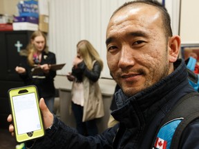 Zack Zhang, a volunteer with the University of Alberta's Faculty of Medicine and Dentistry, demonstrates the new digital application used during Homeward Trust's biennial homeless count at Hope Mission in Edmonton, Alberta on Wednesday, October 19, 2016. Ian Kucerak / Postmedia
