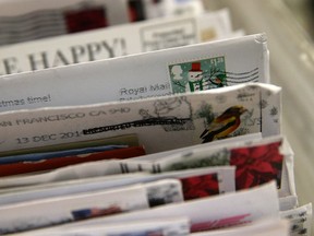 Holiday stamps are seen on mail at the U.S. Post Office sort center on December 18, 2014 in San Francisco, California. (Photo by Justin Sullivan/Getty Images)