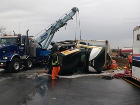 A tractor trailer overturned on the 401 before 6 a.m. Thursday morning, blocking the busy highway's westbound lanes near Woodstock and spilling fuel. The crash forced the detour of morning commuter traffic into Woodstock. Megan Stacey/Woodstock Sentinel Review/Postmedia Network