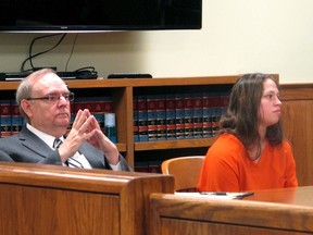 In this Aug. 20, 2015, file photo, Brittany Pilkington, right, and her attorney Marc Triplett, left, listen as a judge sets a $1 million bond in her case during a hearing in Bellefontaine, Ohio.(AP Photo/Andrew Welsh-Huggins, File)