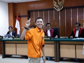 Islamic militant Dodi Suridi gestures as he enters the court room prior to the start of his sentencing hearing at West Jakarta District Court in Jakarta, Indonesia, Thursday, Oct. 20, 2016. The court sentenced Suridi to 10 years in prison for his involvement in a suicide bombing and gun attack in the capital Jakarta earlier this year. (AP Photo/Tatan Syuflana)