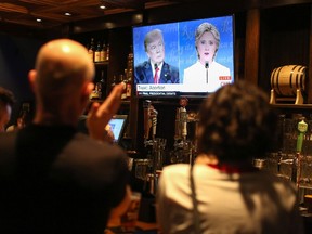 People watch the third presidential debate between presidential debate between US Democratic presidential candidate Hillary Clinton and US Republican presidential candidate Donald Trump at Murphy's Tap House in uptown Charlotte, North Carolina on October 19, 2016. / AFP PHOTO / Logan CyrusLOGAN CYRUS/AFP/Getty Images