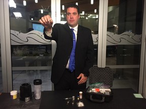 RCMP E Division Cpl. Eric Boechler holds up a vial containing 2 mg of a substance, meant to demonstrate just how small of a quantity of fentanyl is required for a lethal dose. Boechler was in attendance at an RCMP Alberta conference on the deadly drug, held in Sherwood Park on Oct. 20 and 21, 2016. PAIGE PARSONS