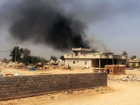 Smoke rises after clashes between Kurdish peshmerga forces and Islamic State group militants, at a village just south of the oil-rich city of Kirkuk, 180 miles (290 kilometers) north of Baghdad, Iraq, Monday, April 20, 2015. (AP Photo)