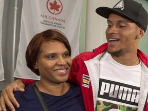 Runner Andre De Grasse hugs his mother Beverley as he arrives in Toronto on Wednesday August 24, 2016. The 22-year-old from Markham, Ont., has taken a two-month break from training and back at the University of California, finishing his sociology degree - fulfilling a promise he made to his mom Beverley last year. (THE CANADIAN PRESS/Chris Young)