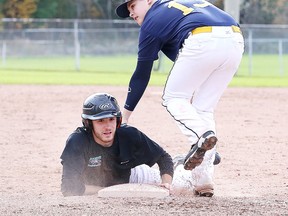 Alexander Bishop Carter's Jacob Lewis tries to tag out Eric Rainville of ƒcole Secondaire Catholique L'Horizon as he slides safely to third base during the city high school baseball championships in Sudbury, Ont. on Thursday October 20, 2016. Gino Donato/Sudbury Star/Postmedia Network