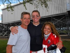 Redblacks quarterback Trevor Harris (centre) with his dad Tom and mother Suzanne.