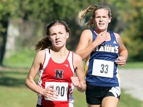 Kaylee White (190) of the Northern Vikings leads Payton Sabourin (33) of the Chatham-Kent Golden Hawks in the junior girls' race at the LKSSAA cross-country championship at Willow Ridge Golf & Country Club in Blenheim, Ont., on Wednesday, October 19, 2016. Sabourin came back to edge White for the win. Mark Malone/Chatham Daily News/Postmedia Network