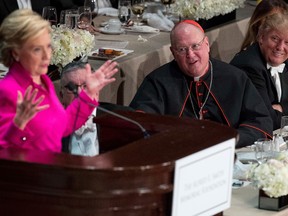 Democratic presidential candidate Hillary Clinton, accompanied by Cardinal Timothy Dolan, Archbishop of New York, and Republican presidential candidate Donald Trump, right, at the 71st annual Alfred E. Smith Memorial Foundation Dinner, a charity gala organized by the Archdiocese of New York, Thursday, Oct. 20, 2016, at the Waldorf Astoria hotel in New York. (AP Photo/Andrew Harnik)