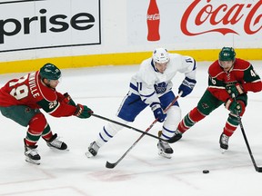 Maple Leafs' Zach Hyman controls the puck through the defence of the Wild's Jason Pominville (left) and Jared Spurgeon (right) during first period NHL action in St. Paul, Minn., on Thursday, Oct. 20, 2016. (Stacy Bengs/AP Photo)