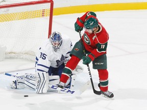 Jhonas Enroth makes a save on Wild’s Zach Parise on Thursday night in Minnesota. (GETTY IMAGES)